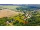 Aerial view of a large grassy lot with mature trees and buildings; property lines are approximate at 4644 E 150 N, Anderson, IN 46012