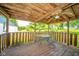 Covered back porch with ceiling fan, table, chairs, and outdoor space to relax and unwind at 4644 E 150 N, Anderson, IN 46012