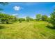 Expansive backyard featuring lush greenery, mature trees, and ample space for outdoor activities at 4644 E 150 N, Anderson, IN 46012
