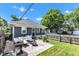 Backyard patio includes outdoor seating, a grill, a fire pit, and a lush lawn at 4721 Carrollton Ave, Indianapolis, IN 46205