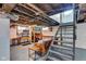 Unfinished basement featuring painted walls, an exposed ceiling with duct work, and metal stairs to the upper level at 4721 Carrollton Ave, Indianapolis, IN 46205