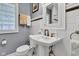 Bathroom featuring hexagon tile floor, a pedestal sink and glass block window at 4721 Carrollton Ave, Indianapolis, IN 46205