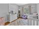 Bedroom room with crib, dresser, and a gray and white rug at 4721 Carrollton Ave, Indianapolis, IN 46205