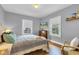 Cozy bedroom featuring hardwood floors, neutral paint, and natural light at 4721 Carrollton Ave, Indianapolis, IN 46205