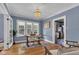 Charming dining room with hardwood floors, chandelier, and natural light at 4721 Carrollton Ave, Indianapolis, IN 46205