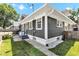 Rear exterior view showing the home's siding, trim, access door, and walkway at 4721 Carrollton Ave, Indianapolis, IN 46205