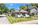 View of charming home with a manicured lawn, established trees, and a classic chimney at 4721 Carrollton Ave, Indianapolis, IN 46205