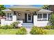 Inviting front porch with seating and colorful hanging flower baskets at 4721 Carrollton Ave, Indianapolis, IN 46205