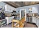 Kitchen with stainless steel appliances, tile floors, white cabinets, and a moveable kitchen island at 4721 Carrollton Ave, Indianapolis, IN 46205