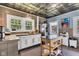 Bright kitchen with stainless steel appliances, tile ceiling, and kitchen island for food prep and serving at 4721 Carrollton Ave, Indianapolis, IN 46205