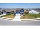 A stunning aerial view of a blue two-story home featuring a paved driveway and manicured lawn at 507 Redvine Dr, Sheridan, IN 46069