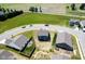 Aerial view of a blue two-story home surrounded by green fields, a pond, and a quiet neighborhood at 507 Redvine Dr, Sheridan, IN 46069