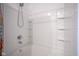 Bright white bathroom with large tub and shower featuring built in shelving for bath accessories at 507 Redvine Dr, Sheridan, IN 46069