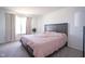 Cozy bedroom featuring a comfortable bed with a pink comforter and soft natural light at 507 Redvine Dr, Sheridan, IN 46069