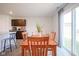 Bright dining room with wood table set, offering sliding glass door access to the outdoors at 507 Redvine Dr, Sheridan, IN 46069
