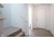 Bright hallway and stairwell, leading to main entry and featuring modern flooring at 507 Redvine Dr, Sheridan, IN 46069