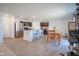 Open-concept kitchen with stainless steel appliances, a breakfast bar, dining area, and sleek flooring at 507 Redvine Dr, Sheridan, IN 46069