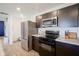 Stylish kitchen with stainless steel appliances, modern countertops, and ample cabinet storage at 507 Redvine Dr, Sheridan, IN 46069