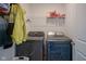 Convenient laundry room features modern washer and dryer, plus overhead shelving for storage at 507 Redvine Dr, Sheridan, IN 46069