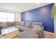 Comfortable living room with a large gray sectional, stylish coffee table, and a pop of color at 507 Redvine Dr, Sheridan, IN 46069