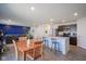 Open-concept space showcasing dining area, kitchen island, and living area with blue accent wall at 507 Redvine Dr, Sheridan, IN 46069