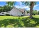 Charming backyard with lush lawn, mature trees, and inviting patio area perfect for outdoor relaxation at 5821 Pemberly Dr, Indianapolis, IN 46221