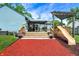 Wooden backyard deck featuring a slide, pergola, flowers, and lounge area at 5821 Pemberly Dr, Indianapolis, IN 46221
