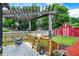 Backyard deck featuring a red barn, pergola, and swing, perfect for outdoor living at 5821 Pemberly Dr, Indianapolis, IN 46221