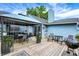 Expansive outdoor deck with dining and grilling area, covered seating, and a serene backyard view at 5821 Pemberly Dr, Indianapolis, IN 46221