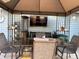 Outdoor dining set beneath a gazebo on a cozy back deck with a mounted tv and heater at 5821 Pemberly Dr, Indianapolis, IN 46221