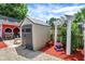 Backyard featuring red mulch border, pergola, storage shed, and small red wagon at 5821 Pemberly Dr, Indianapolis, IN 46221