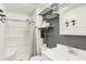 The bathroom features a shower, sink, toilet and shelving with modern black and white decor at 5821 Pemberly Dr, Indianapolis, IN 46221