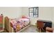 Cozy bedroom with a window for natural light, a floral bedspread, and a desk at 5821 Pemberly Dr, Indianapolis, IN 46221