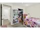 Bright bedroom featuring a colorful book shelf, and a floral bedspread, creating a cheerful ambiance at 5821 Pemberly Dr, Indianapolis, IN 46221