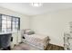 Bright bedroom with large window and twin bed features a closet and dresser at 5821 Pemberly Dr, Indianapolis, IN 46221