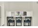 Kitchen bar features three stools and light countertop at 5821 Pemberly Dr, Indianapolis, IN 46221