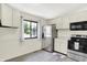 A modern kitchen boasts stainless steel appliances, white cabinets and a bright window view at 5821 Pemberly Dr, Indianapolis, IN 46221