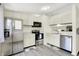 Efficient kitchen with stainless steel appliances and white cabinets and modern fixtures at 5821 Pemberly Dr, Indianapolis, IN 46221