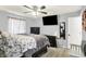 A well-lit main bedroom featuring modern light fixtures, ceiling fan and hardwood floors at 5821 Pemberly Dr, Indianapolis, IN 46221