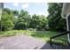 Large deck and green lawn with surrounding trees, perfect for backyard gatherings at 6028 Thornwood Ct, Indianapolis, IN 46250