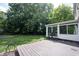 Expansive wooden deck and well-manicured lawn, perfect for entertaining in the green back yard at 6028 Thornwood Ct, Indianapolis, IN 46250