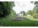 Expansive backyard featuring a unique circular garden and plenty of lush green space for outdoor activities at 6028 Thornwood Ct, Indianapolis, IN 46250