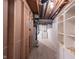 Unfinished basement area with open ceiling, modern mechanics, and plenty of potential storage space at 6028 Thornwood Ct, Indianapolis, IN 46250