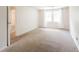 Bright bedroom featuring neutral carpet, double windows, and light walls at 6028 Thornwood Ct, Indianapolis, IN 46250