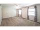Bright bedroom with neutral carpet, ceiling fan, and two windows with decorative curtains at 6028 Thornwood Ct, Indianapolis, IN 46250