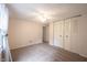 A carpeted bedroom features a ceiling fan, large closet and a view into the hall at 6028 Thornwood Ct, Indianapolis, IN 46250