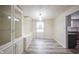 Dining area with built-in cabinets, elegant lighting, and modern flooring at 6028 Thornwood Ct, Indianapolis, IN 46250