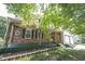 Inviting front porch with wooden beams, brick accents, and hanging plants at 6028 Thornwood Ct, Indianapolis, IN 46250