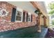 Charming porch with exposed beams, hanging plants, and brick siding at 6028 Thornwood Ct, Indianapolis, IN 46250