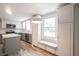 Kitchen featuring white cabinets, stainless appliances, island and window bench seat at 6028 Thornwood Ct, Indianapolis, IN 46250